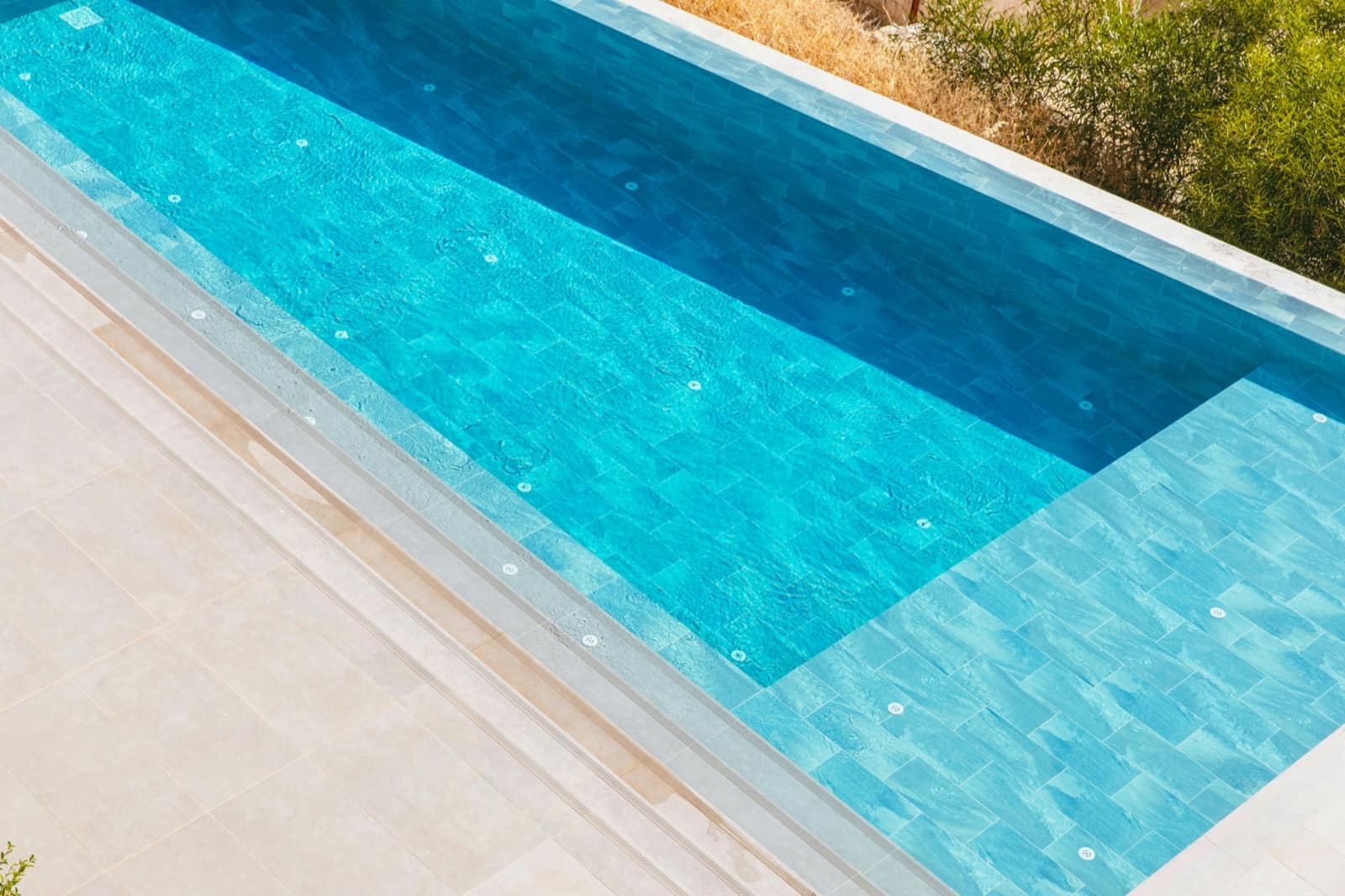 Overhead view of tile and water detail on a finished Tucson pool, the visual portfolio content that ranks